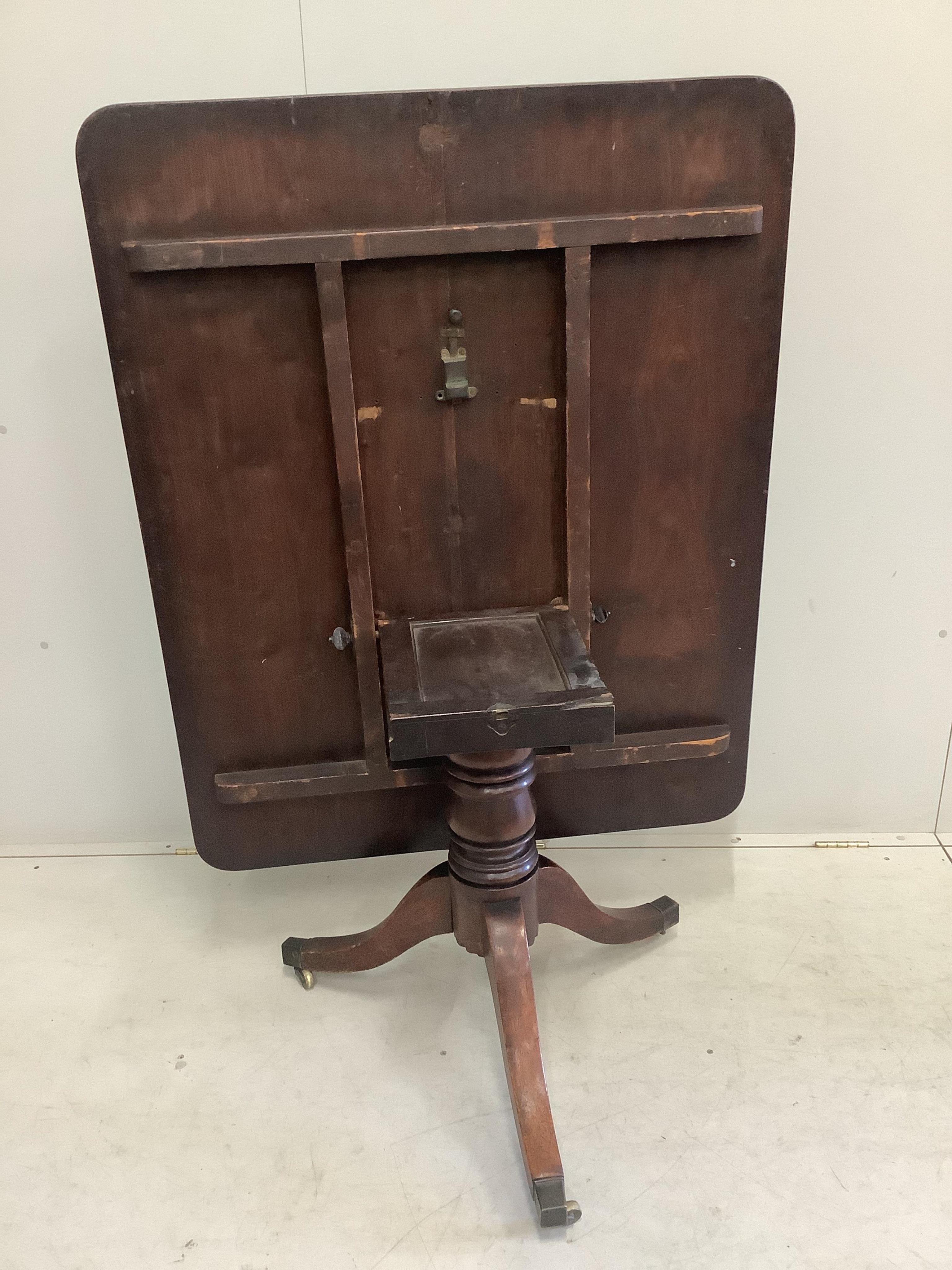 A Regency rectangular mahogany tilt top dining table, width 121cm, depth 97cm, height 70cm. Condition - fair